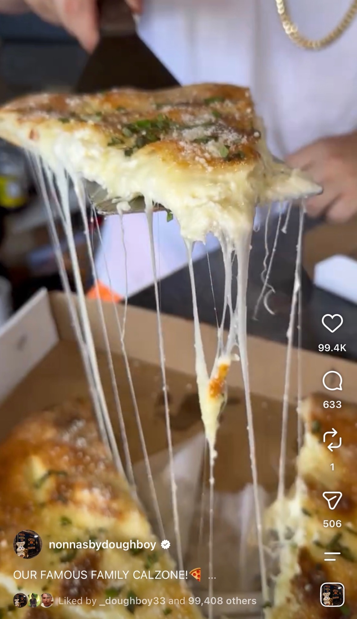 Cheese-filled calzone slice lifted with a long melted cheese pull