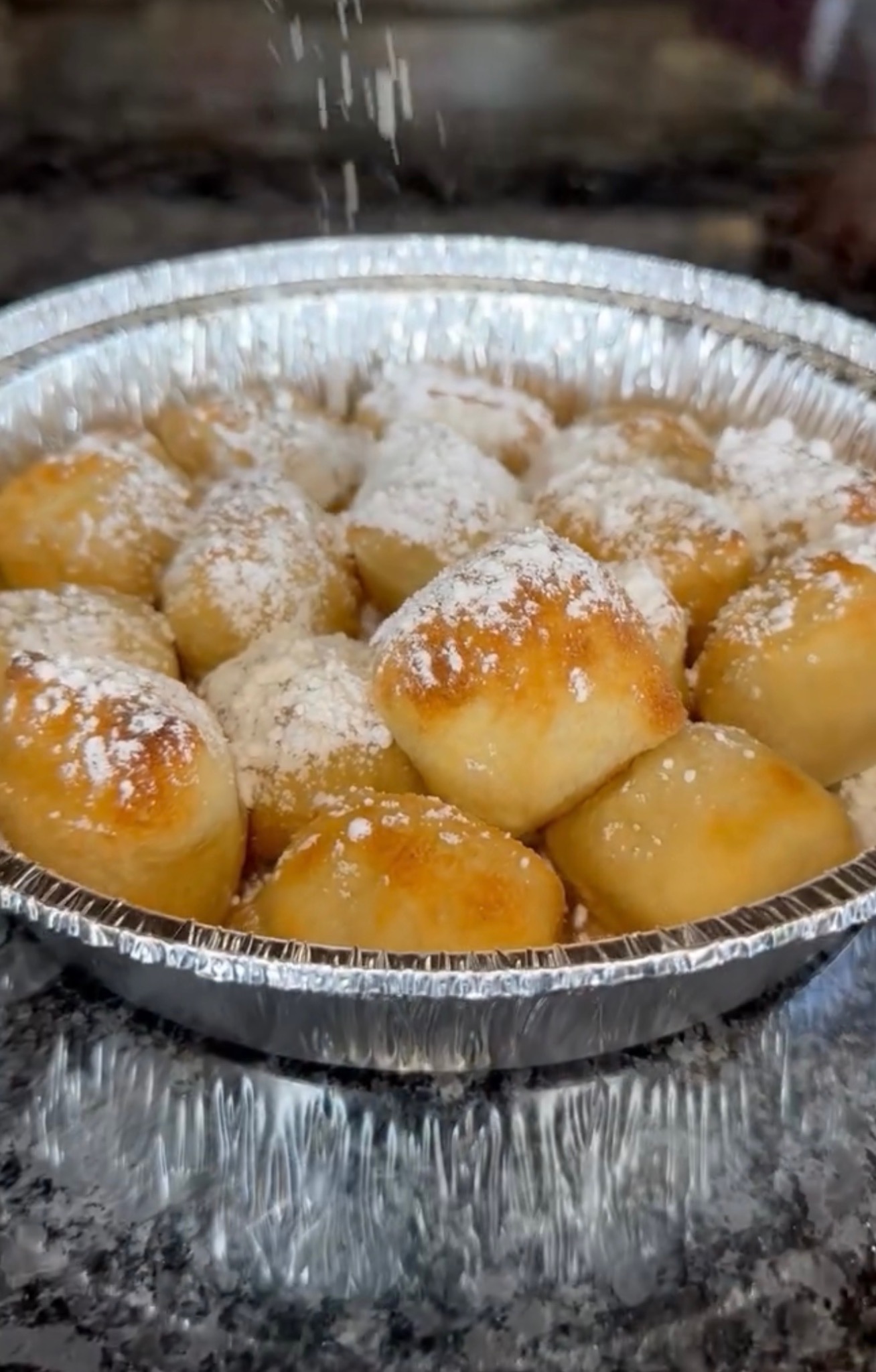 Fresh zeppoles dusted with powdered sugar