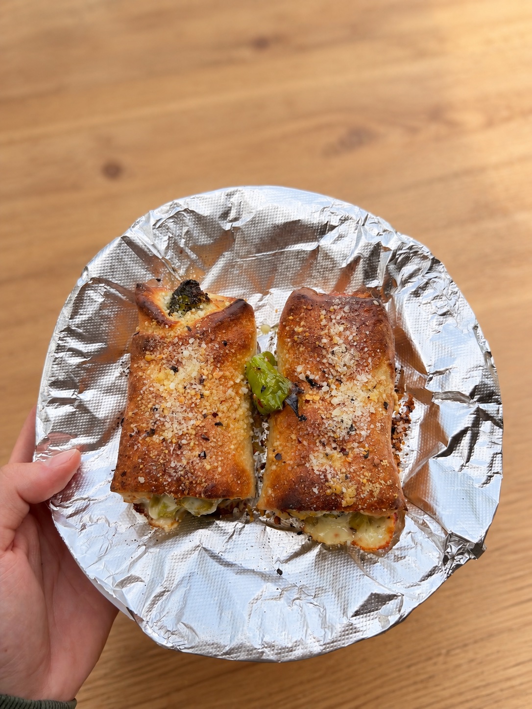 Two freshly baked stuffed rolls served on a round dish